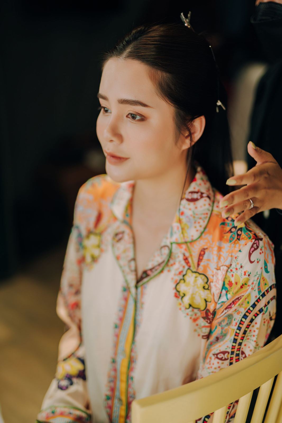 Polished low updo with floral blouse