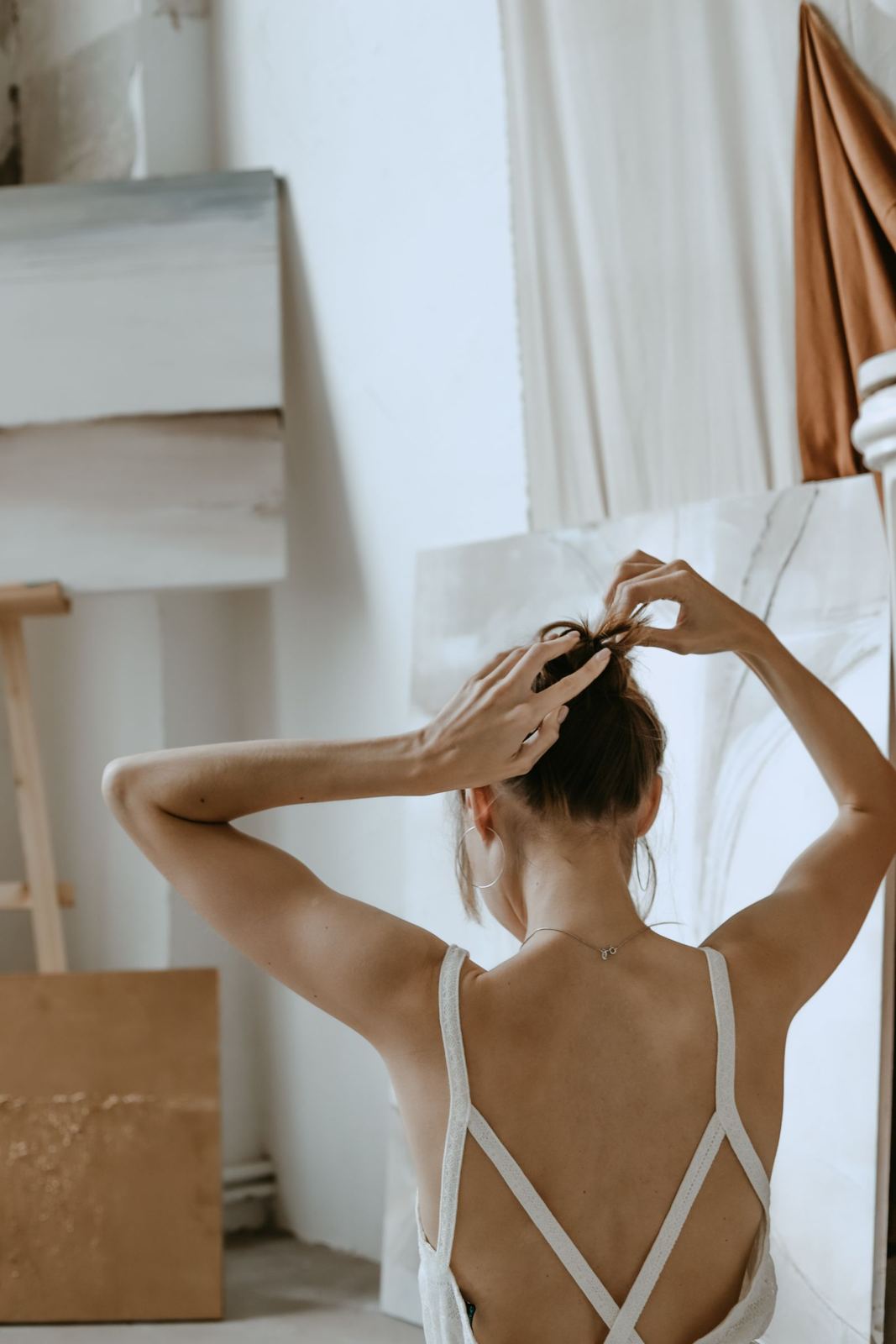 Woman pinning her hair into a high bun