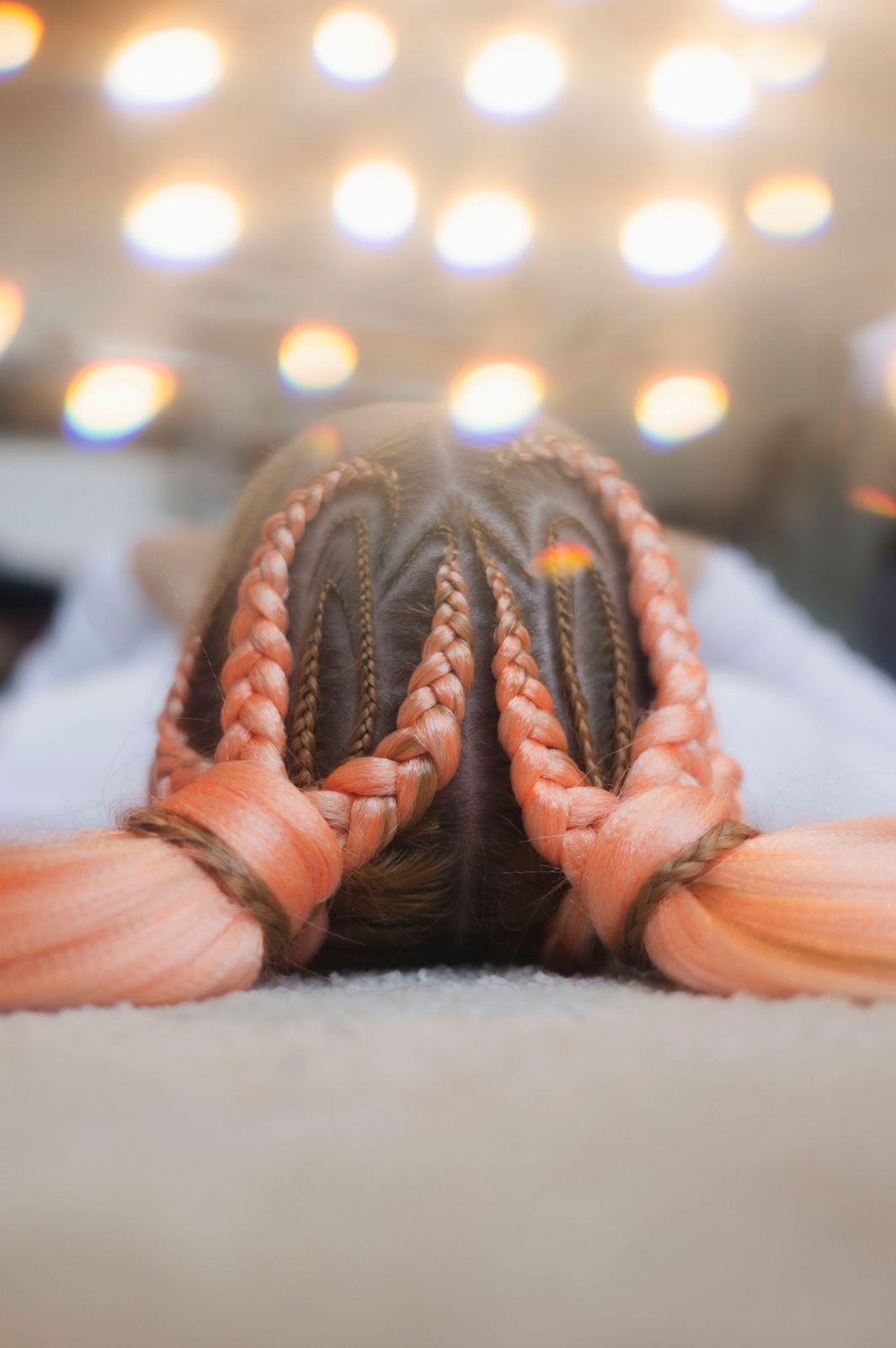 Two peach-toned Dutch braids