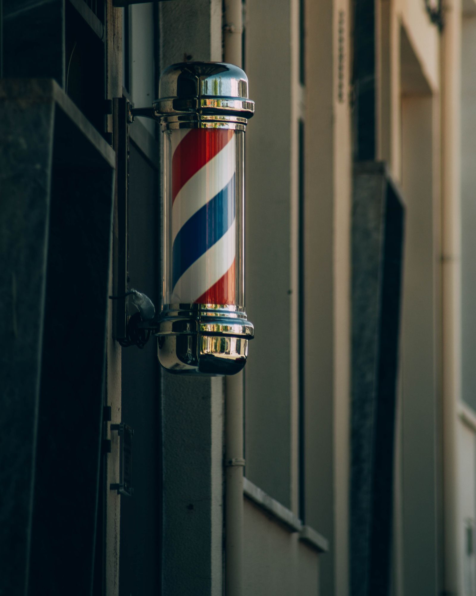Red, white and blue barber pole mounted outside the shop