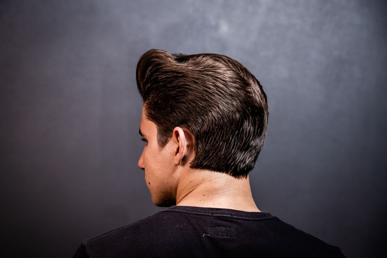 Back view of a sculpted pompadour with a tapered neckline