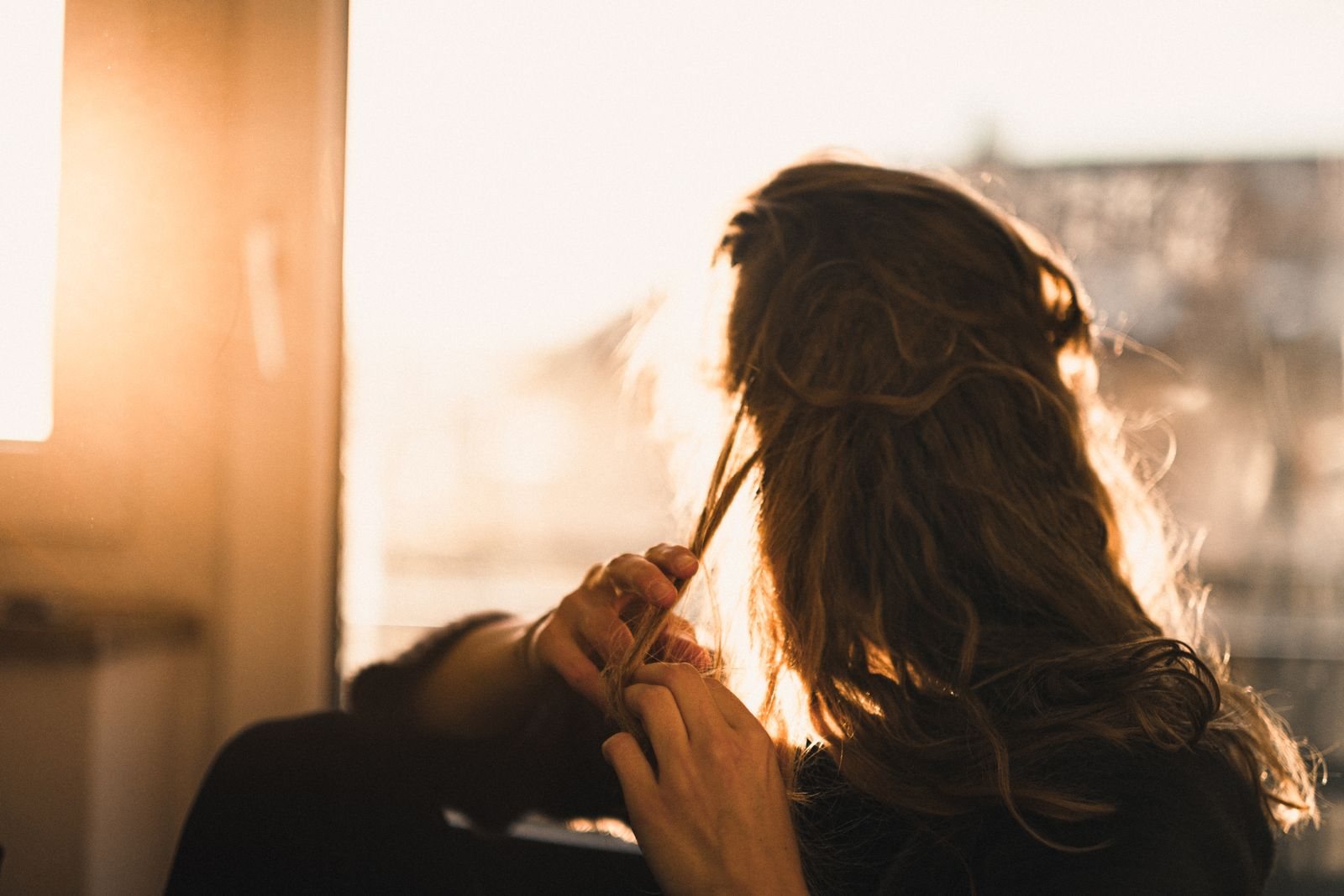 Guest's backlit honey hair in the sunny studio window