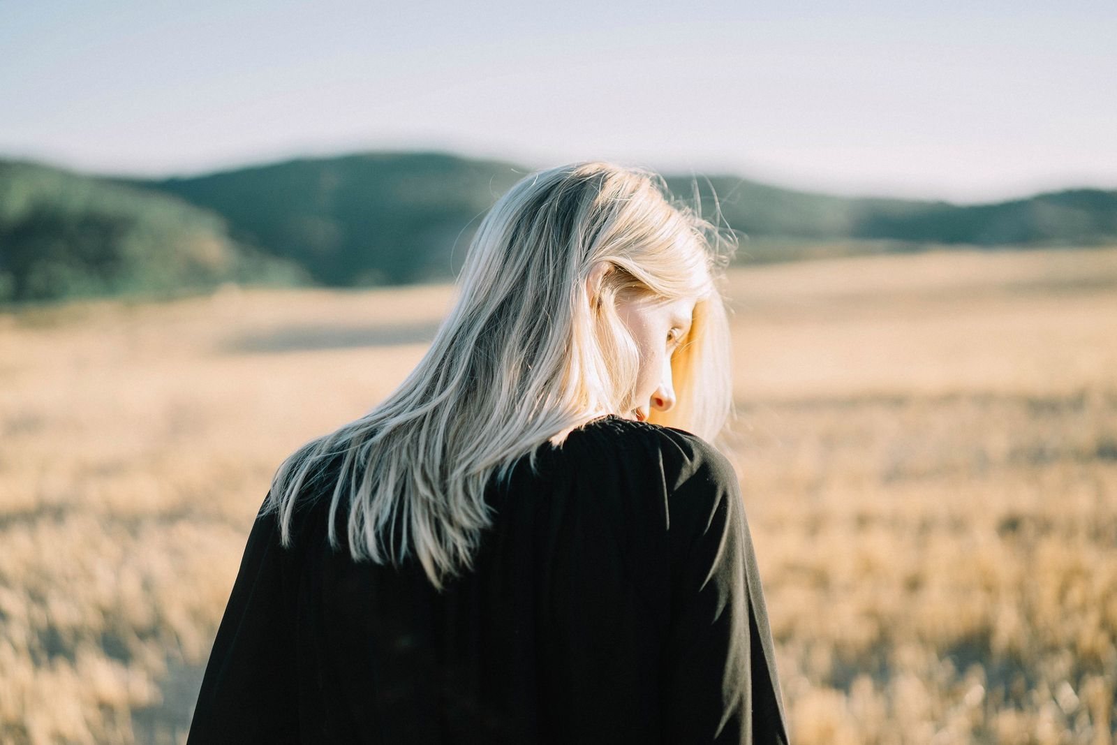 Pale champagne blonde hair in a golden wheat field