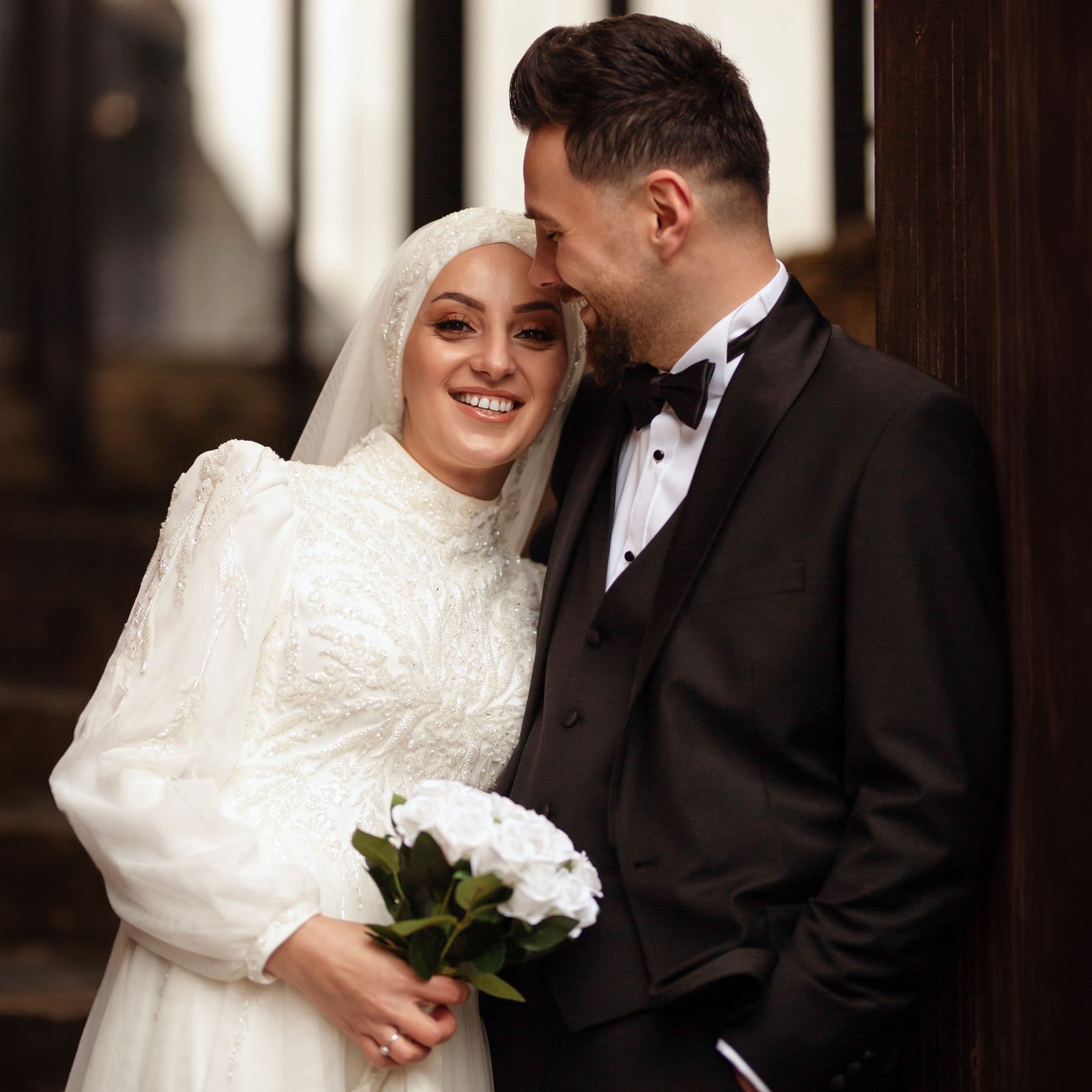 Smiling bride in lace with her groom