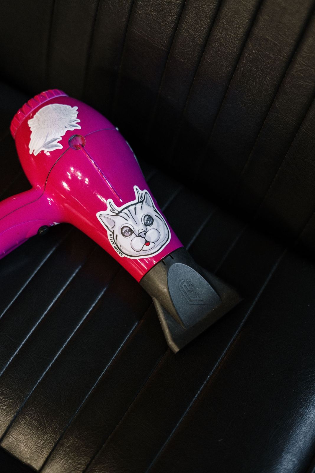 Hot pink blow dryer on a salon chair