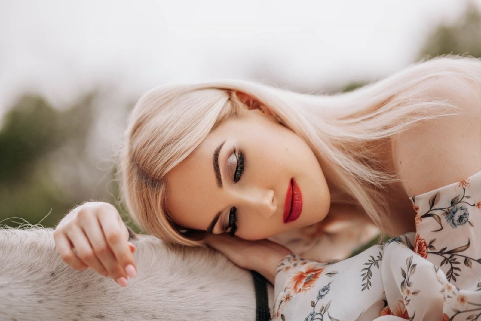 Platinum blonde hair fanned out across a pillow