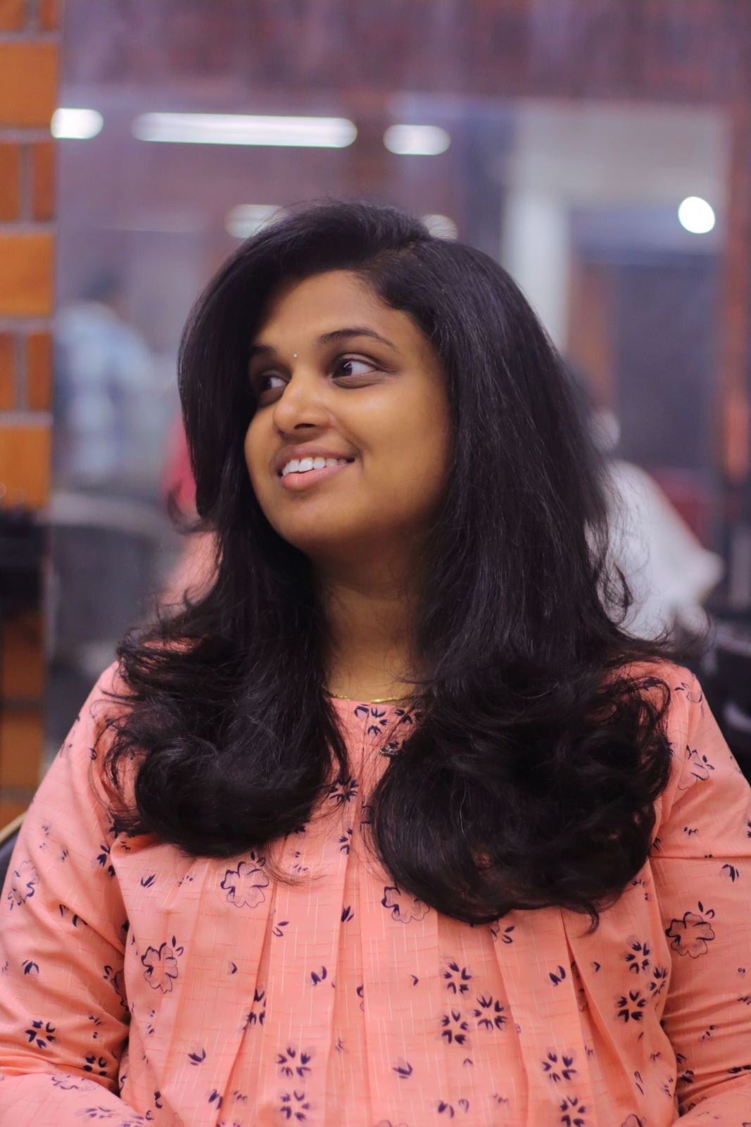 Woman with a glossy, bouncy silk press