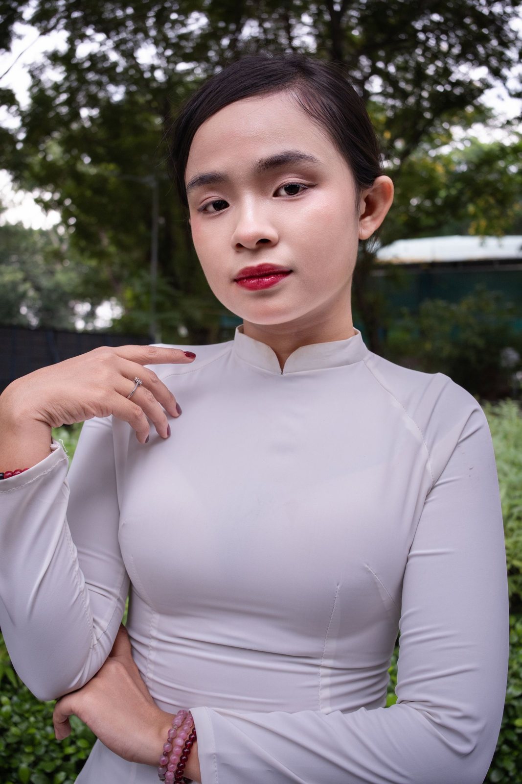 Linh Tran, colorist with sleek dark hair, portrait outdoors