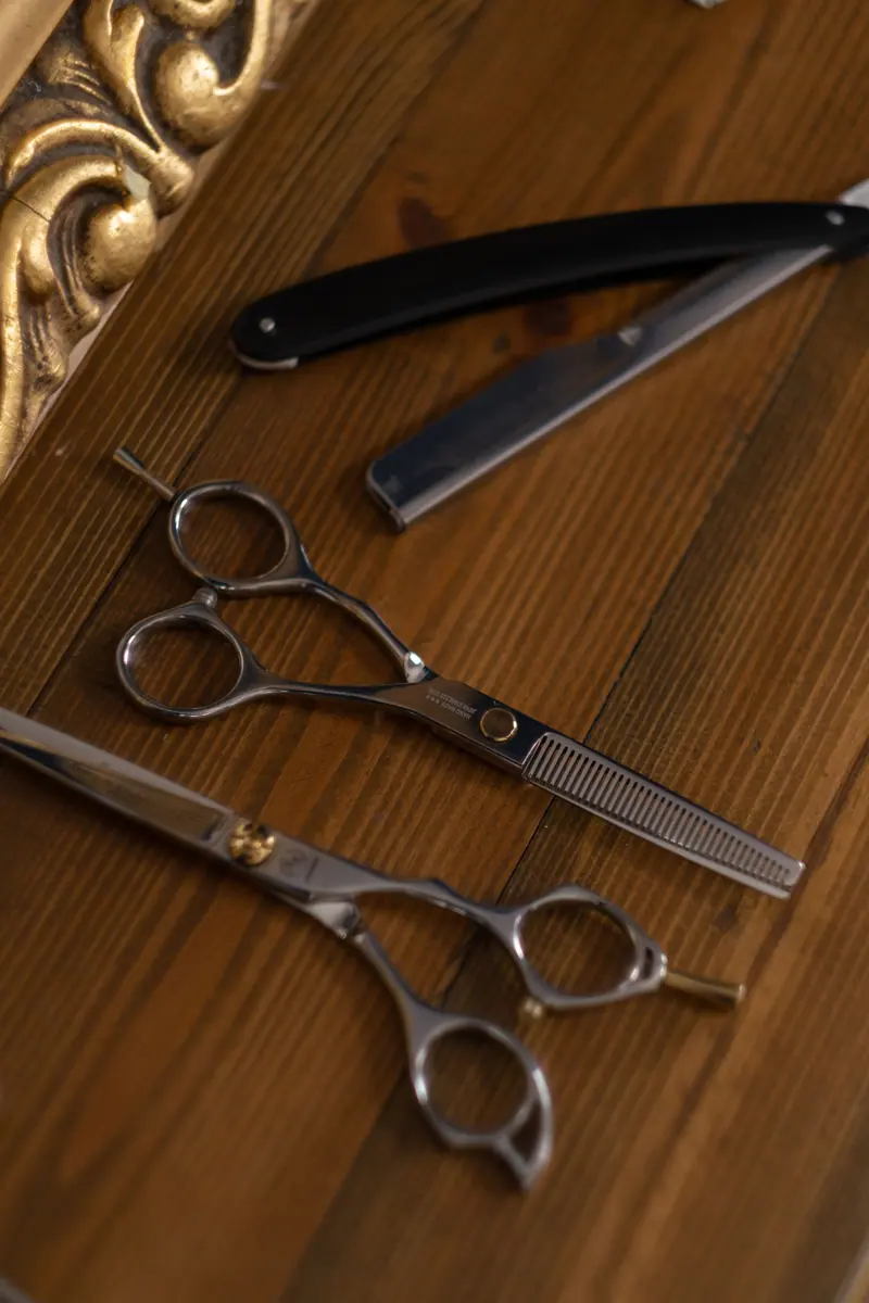 Shears and razor on a gilded tray