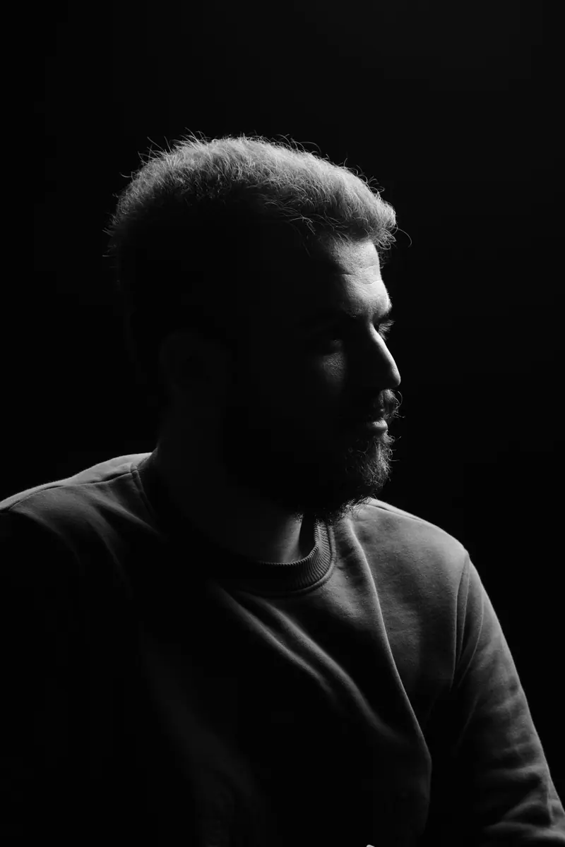 Low-lit portrait of a bearded man