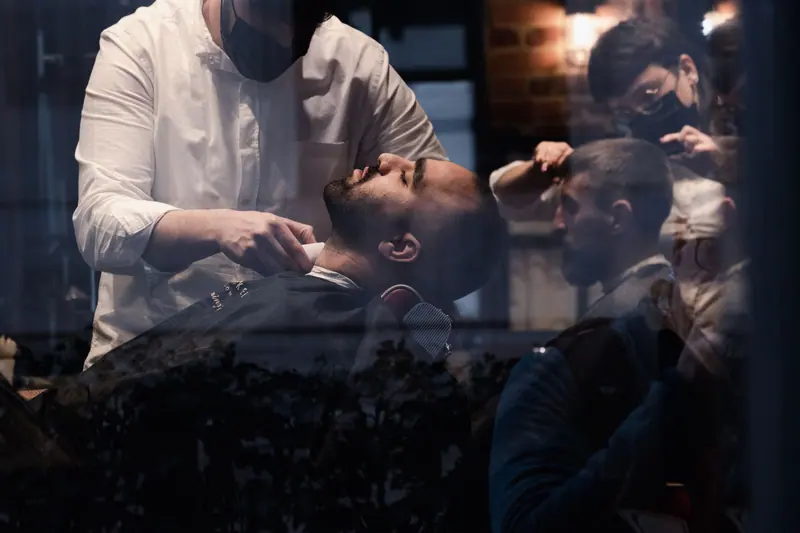 Barbers at work in a moody shop