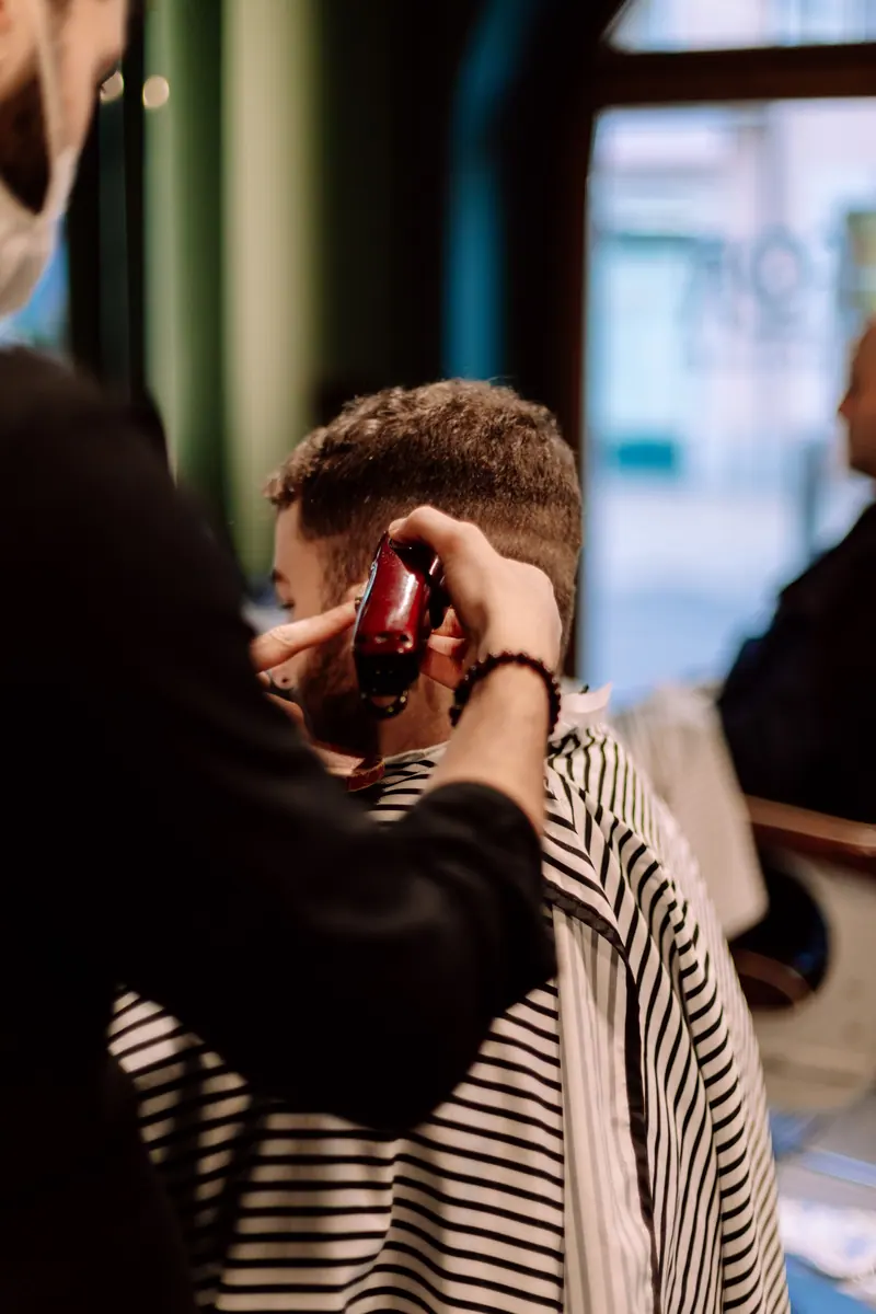 Barber shaping a fade