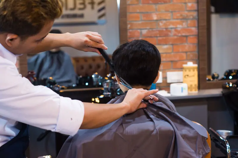 Barber at work in a warm shop