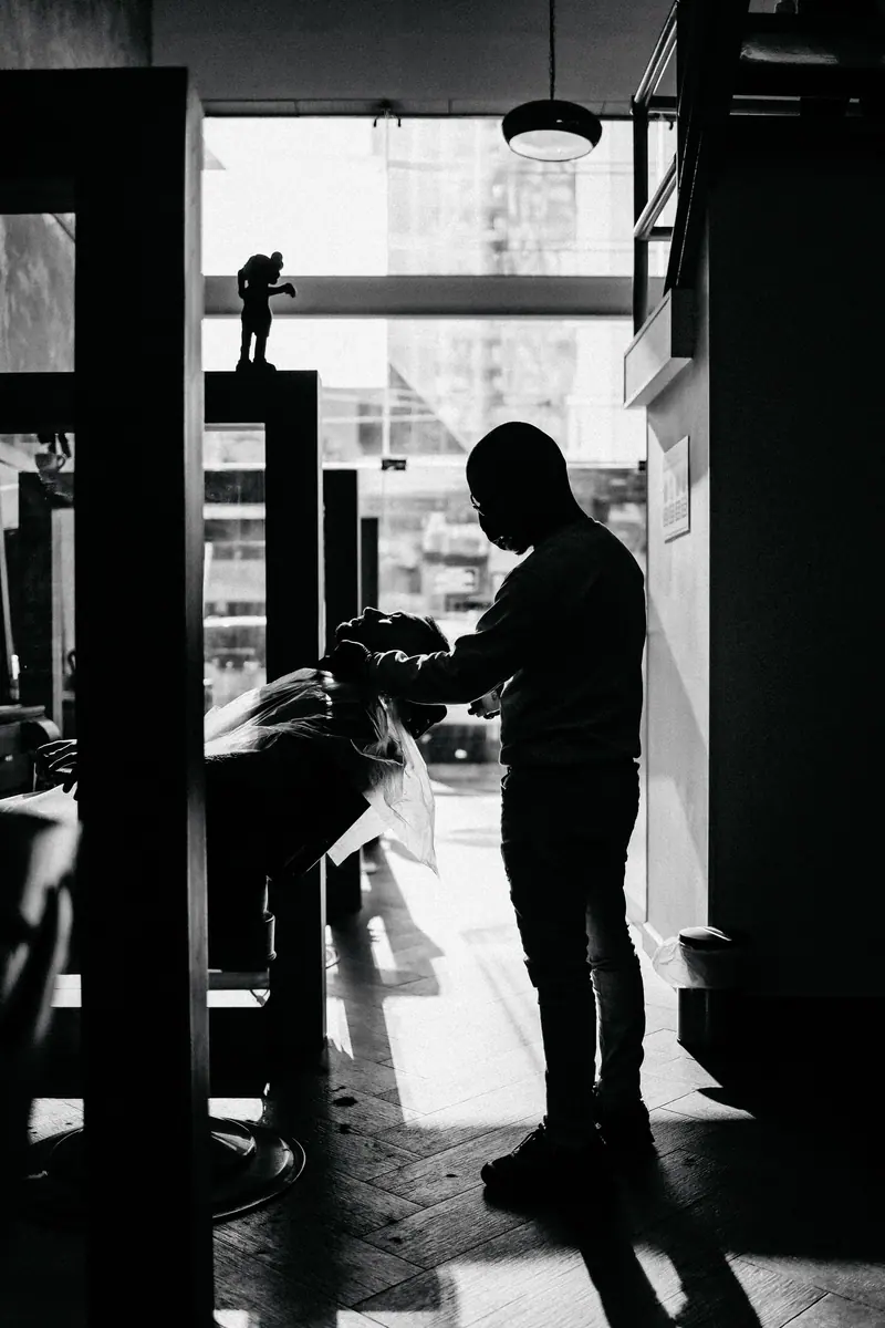 Barber silhouetted in the doorway