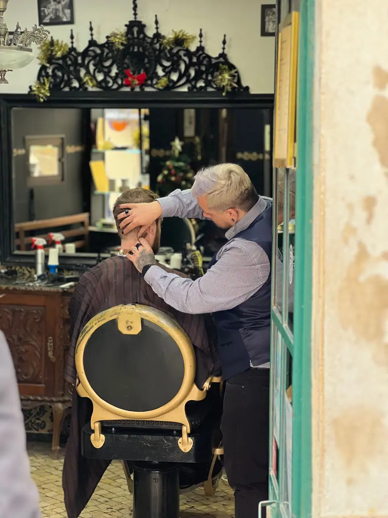 Barber at work in a narrow shop