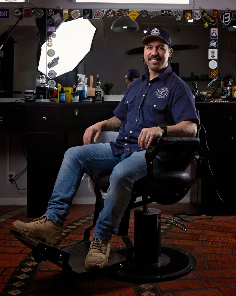 Barber relaxing in a chair in his shop