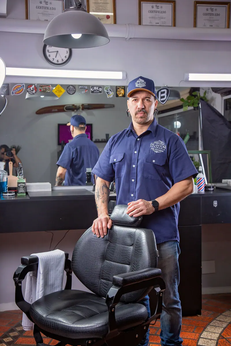 Barber standing by his chair