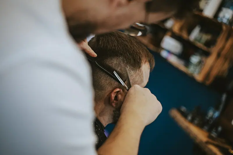Haircut scene in a barber shop capturing the art of modern grooming and styling.