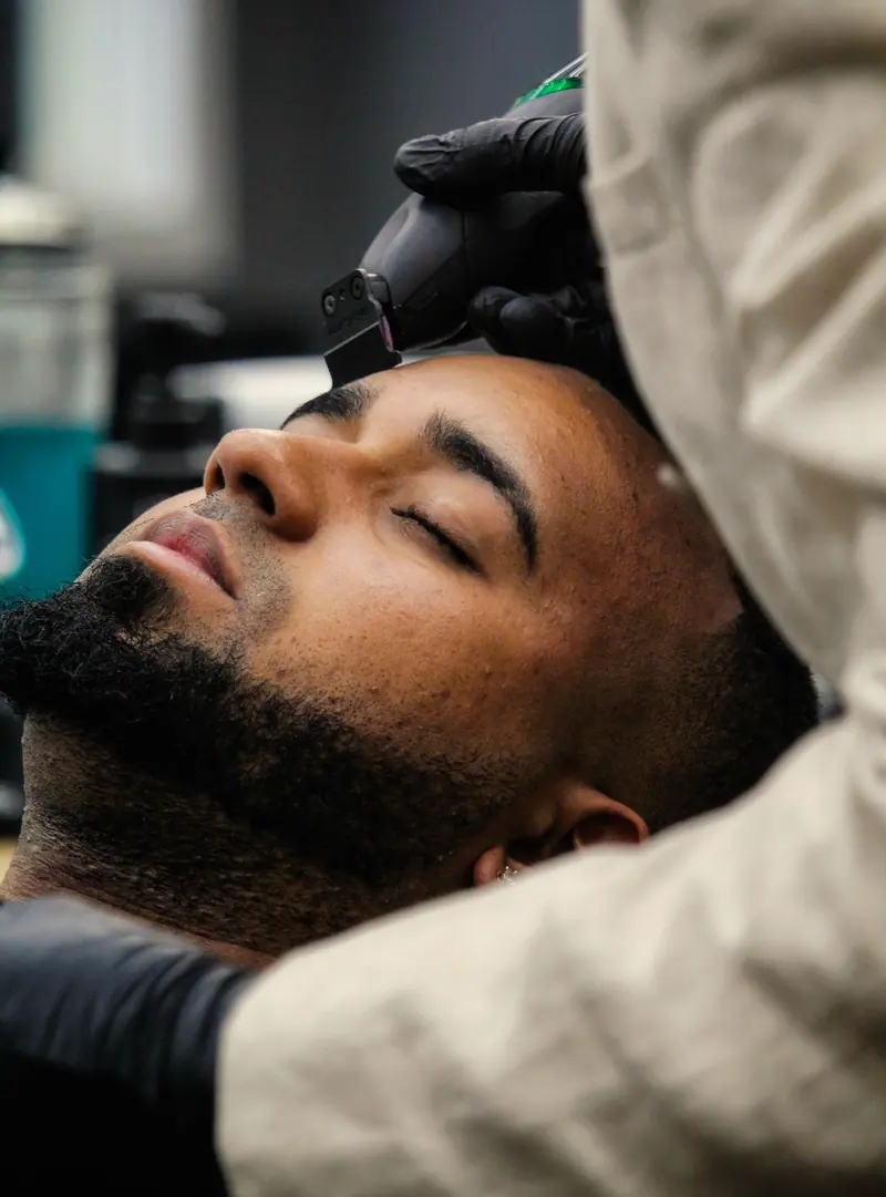 Client relaxing during a beard trim