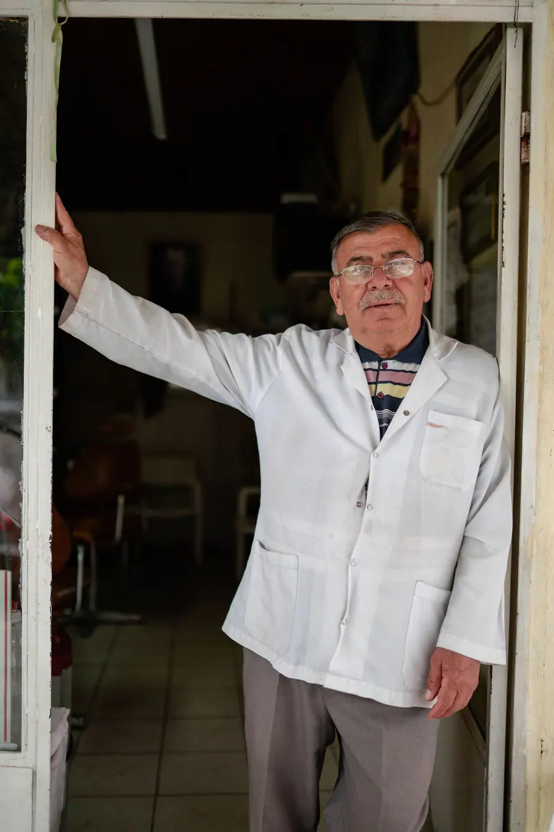 Veteran barber in the doorway