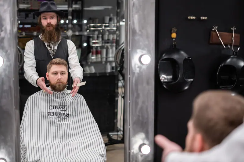 Barber trimming a beard
