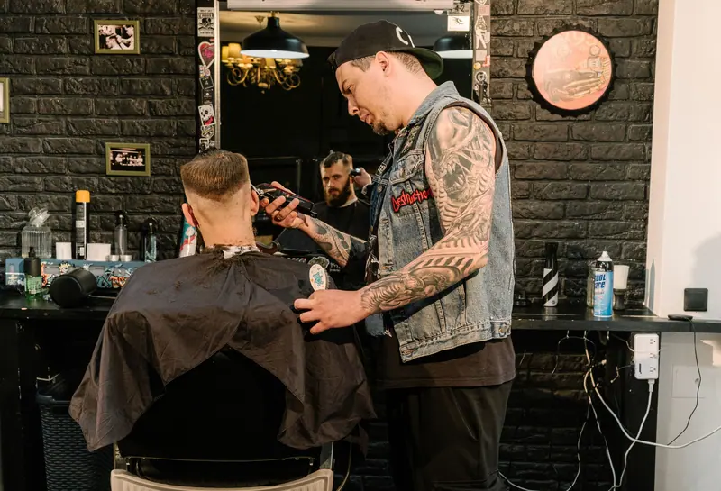 Barber at work in a dark-green hall