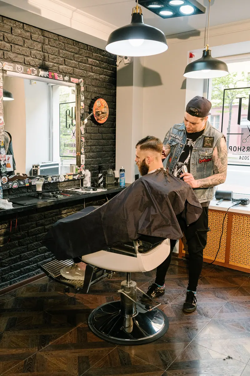 Barber at work in a dark shop