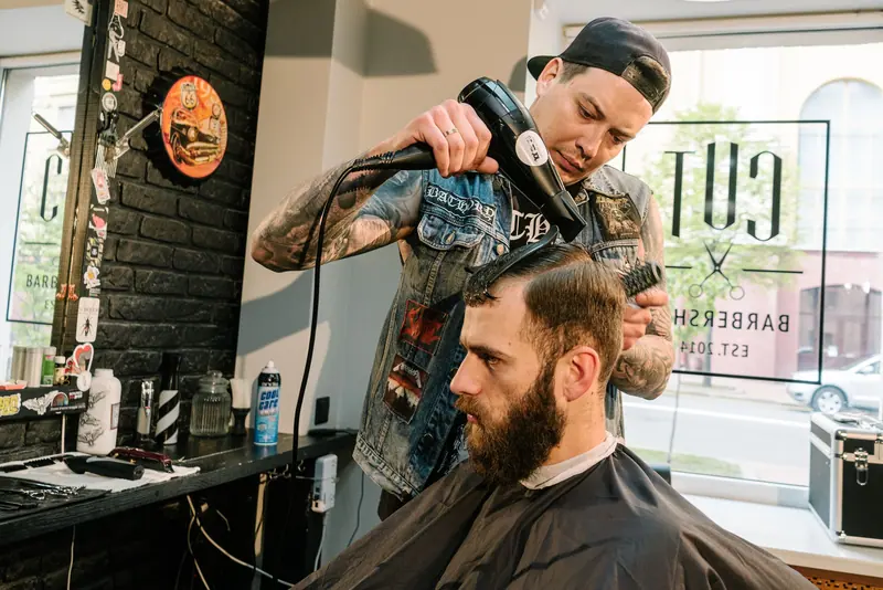 Barber trimming a beard