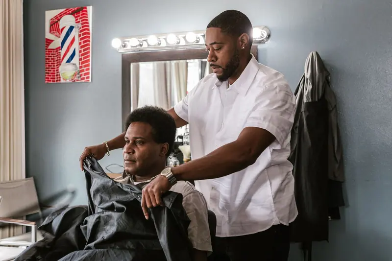 Client in the chair, barber at work