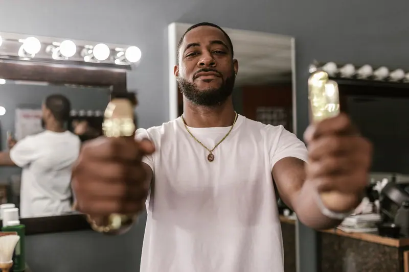 Barber holding clippers to camera