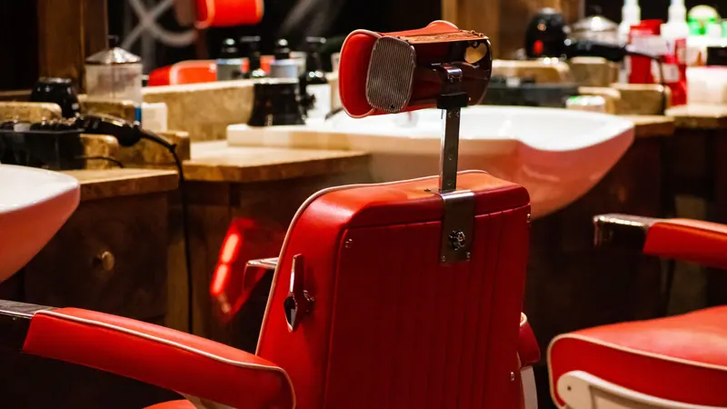 Row of red vintage barber chairs in the shop