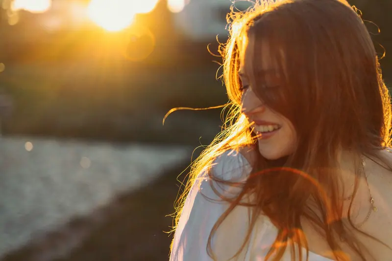 Sunlit smile and soft hair
