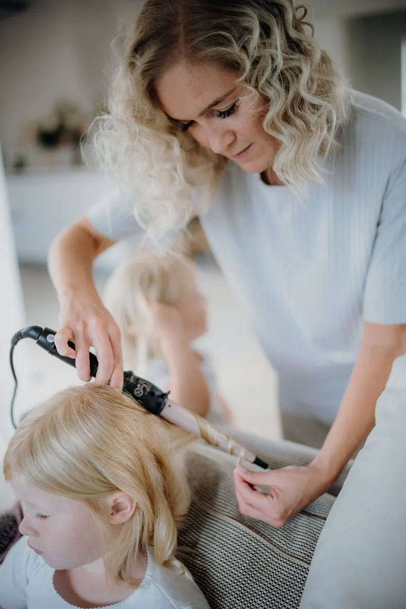 Curling a client's blonde hair