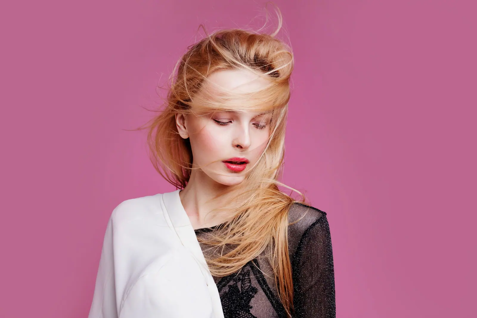 Wind-swept blonde lengths on pink