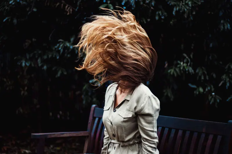 Long dark hair in motion in low light