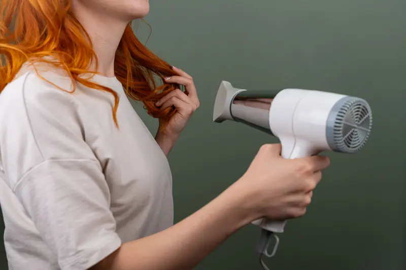 Blow-drying long copper hair