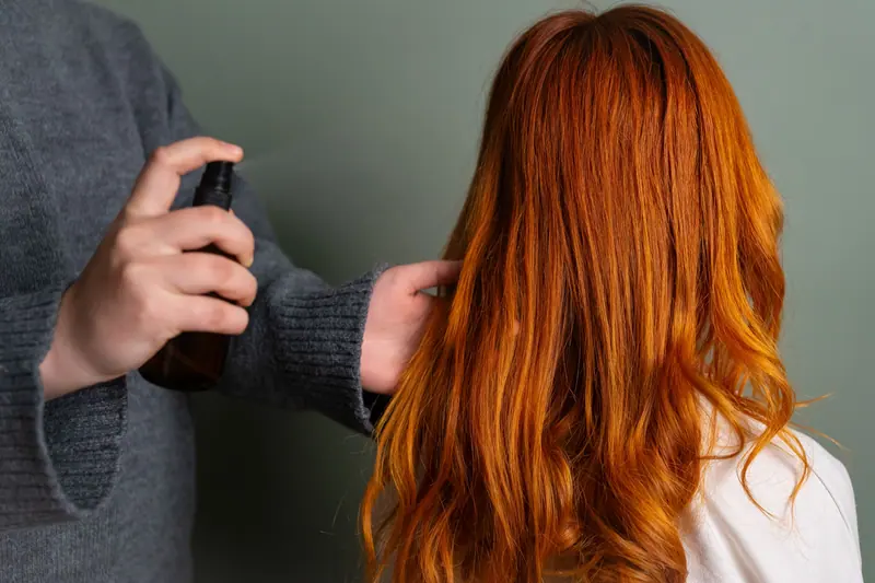 Misting copper hair before blow-drying