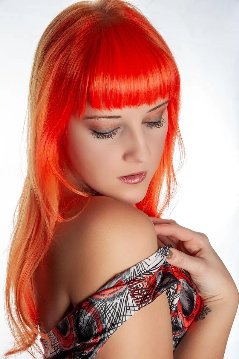 Bright copper-red blunt bangs and sleek lengths