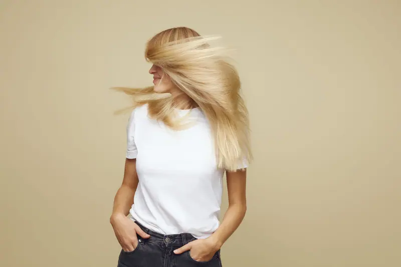 Blonde hair in motion on cream