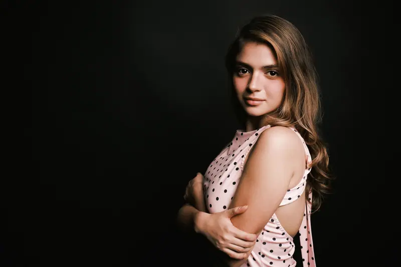 Soft brunette waves on a black backdrop