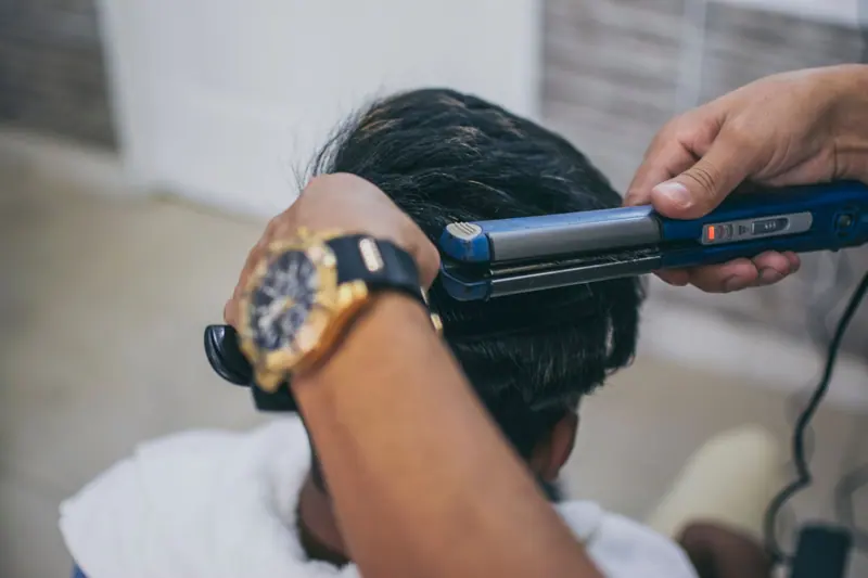 Smoothing hair with a flat iron