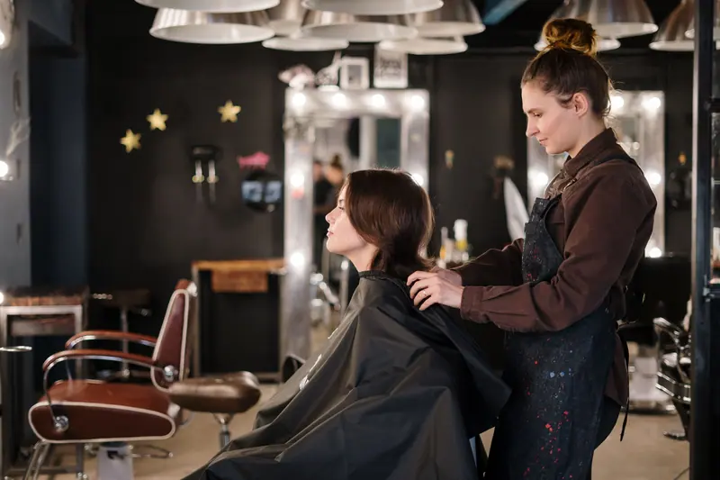 Stylist working under bulb lights