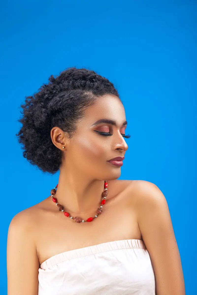 Soft updo against a white wall
