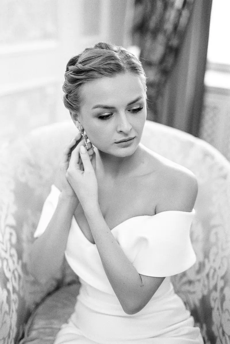 Timeless black and white bridal portrait with elegant earrings.