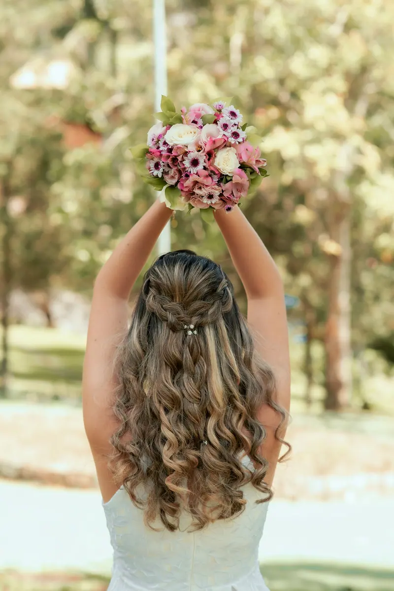 Bride holding a colorful bouquet outdoors, captured in a vibrant setting.