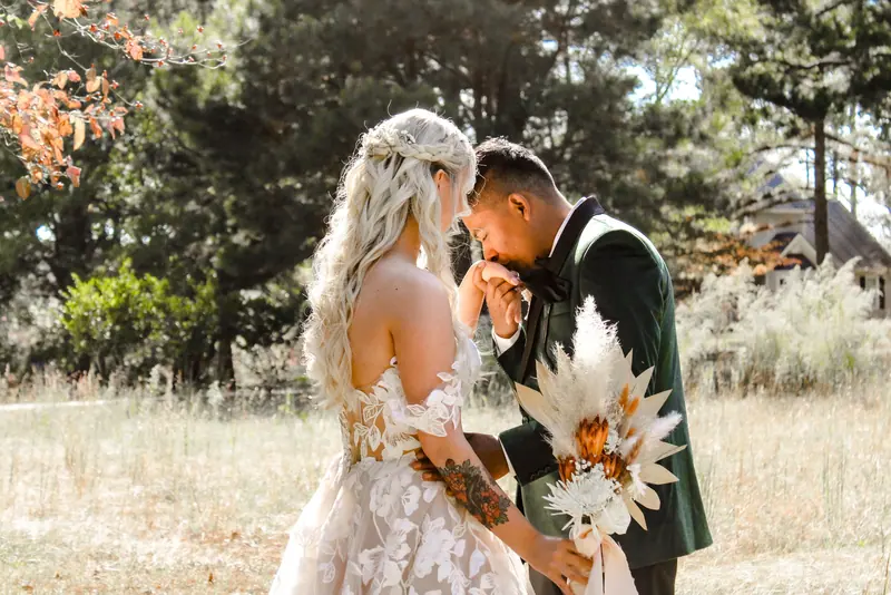 A couple enjoys a romantic outdoor wedding moment in Sanford, NC, surrounded by nature.
