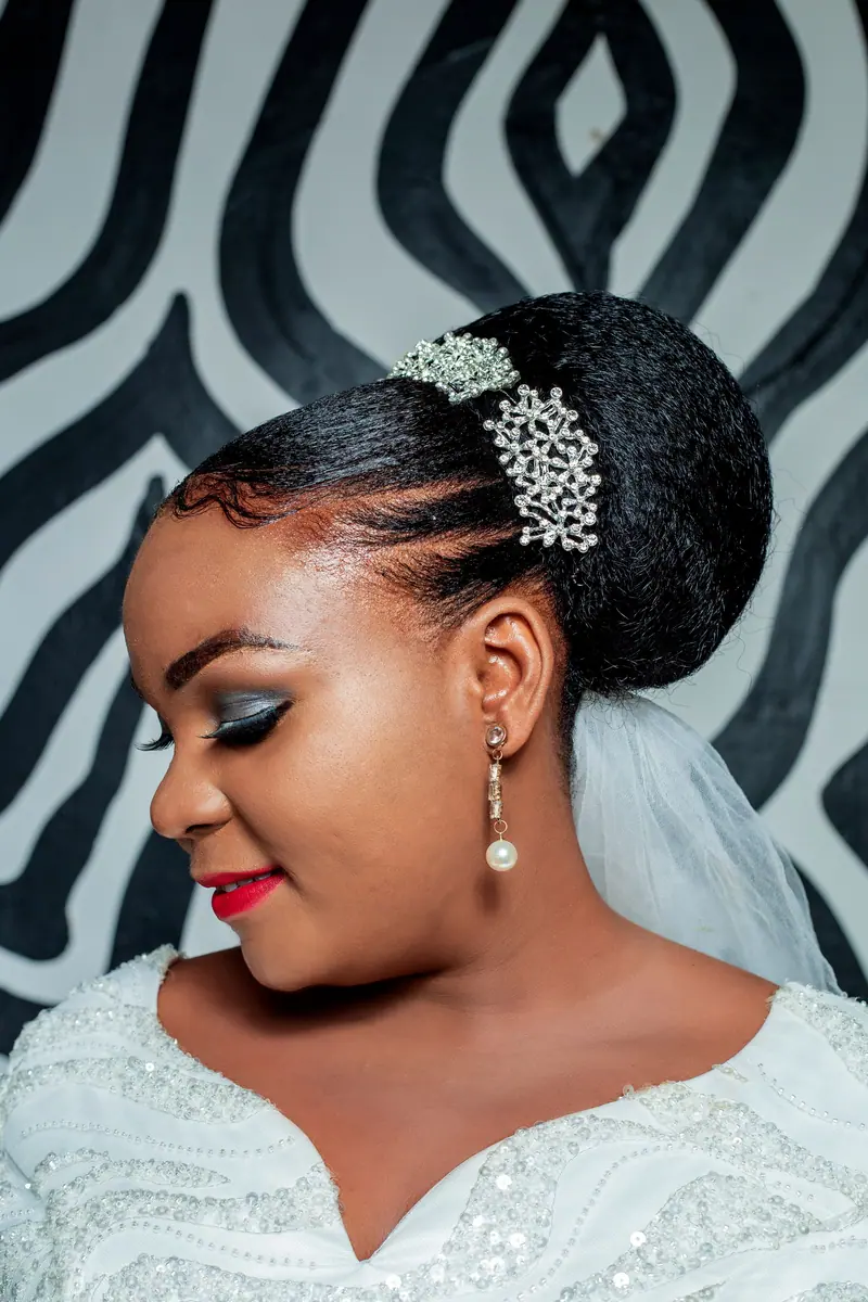 Stunning portrait of a bride with a glamorous updo hairstyle and elegant makeup.