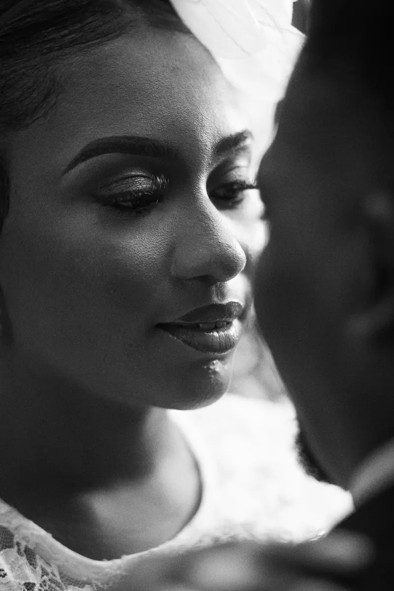 Elegant black and white portrait of a bride in a close embrace, capturing intimacy.