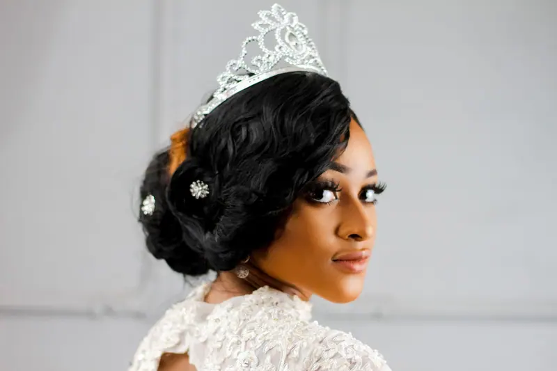 Stunning portrait of a woman wearing a tiara and elegant bridal gown, exuding elegance and grace.
