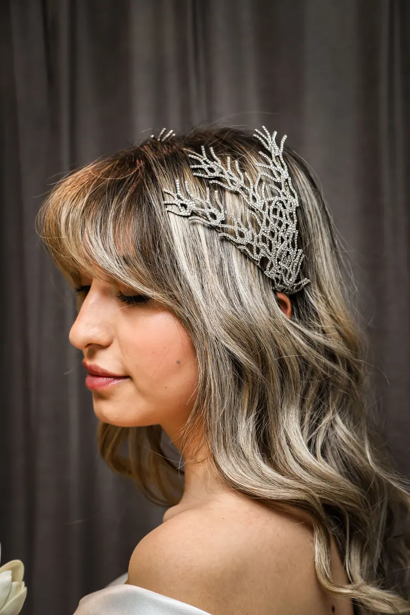 Close-up of a bride with a stylish silver hair accessory. Perfect for wedding themes.